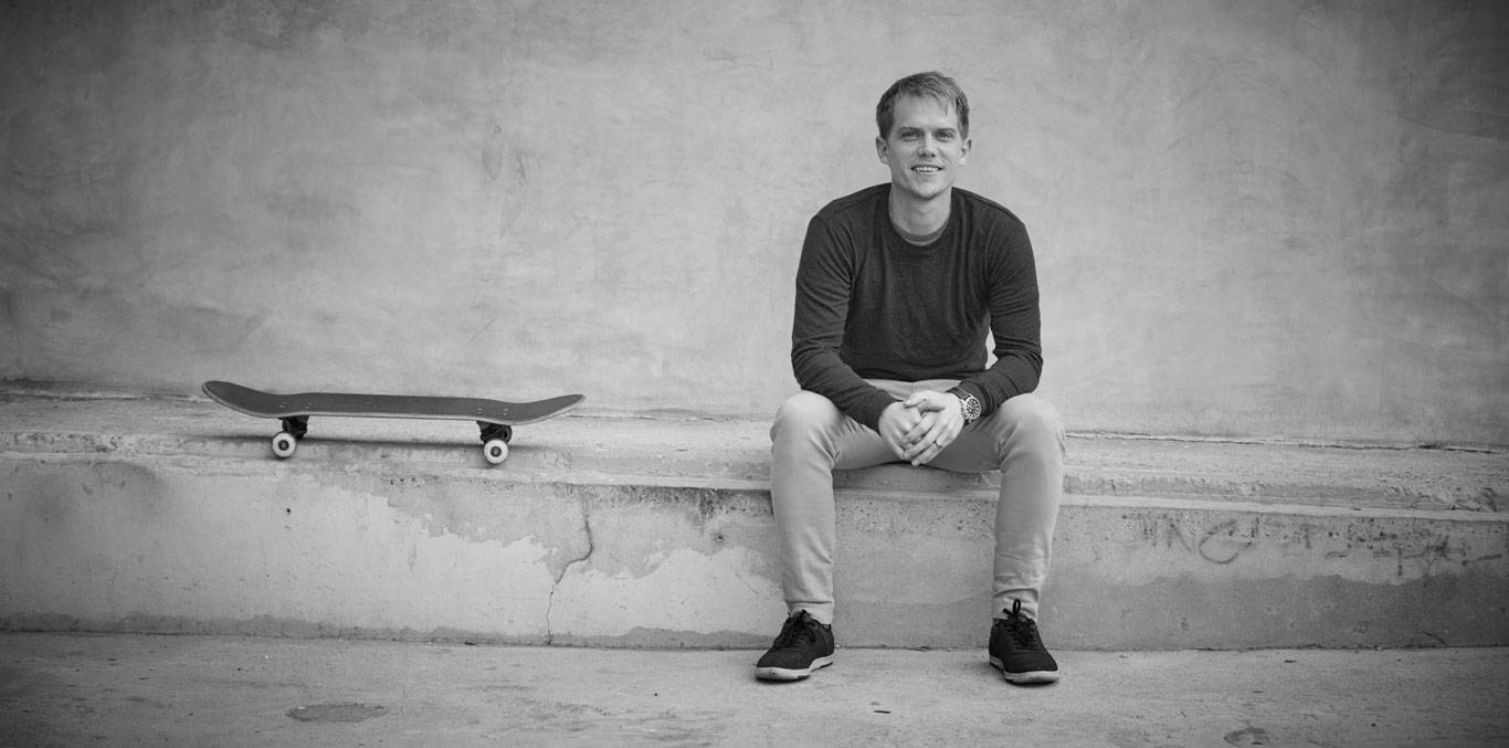 Portrait of Luke Swenson sitting on loading dock